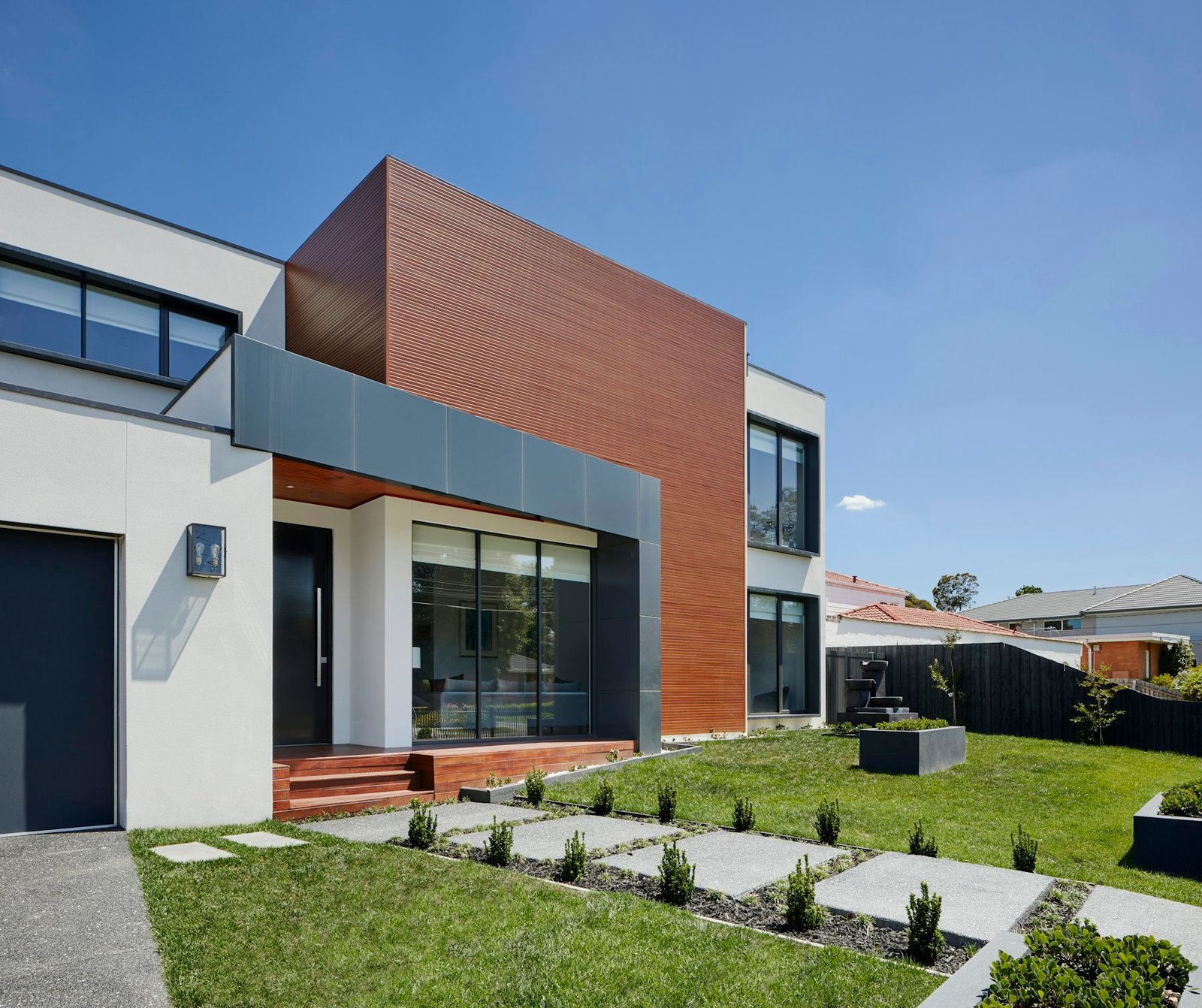 Illustrative contemporary home opening onto a garden; placeholder listing photography